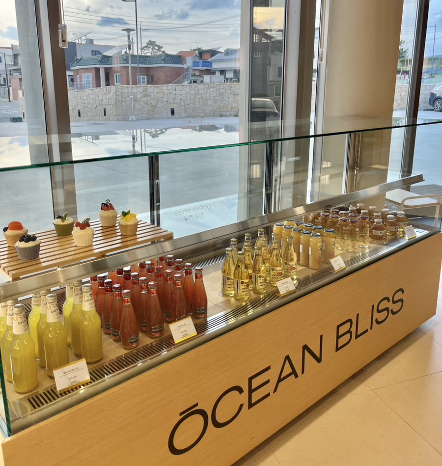 Bottled drink display at the resort cafe - colorful glass bottles and dessert case