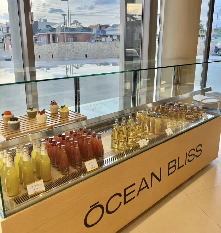 Bottled drink display at the resort cafe - colorful glass bottles and dessert case