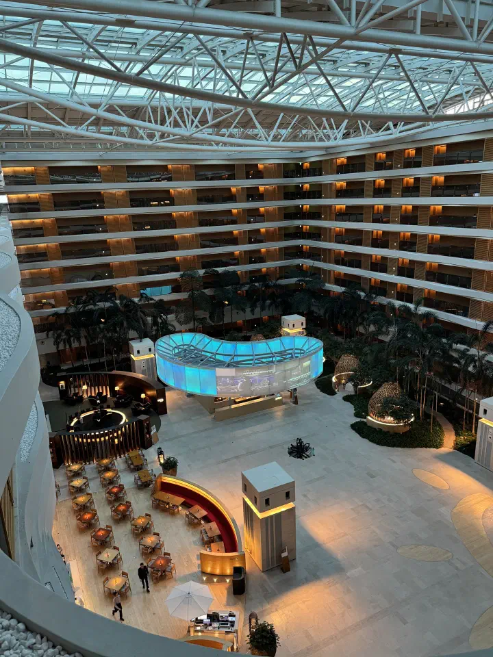 Evening view of the Haevichi Hotel Jeju atrium lobby and Seommora buffet seating
