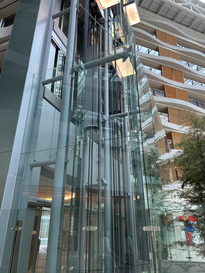 Glass panoramic elevator rising through the atrium at Haevichi Hotel Jeju