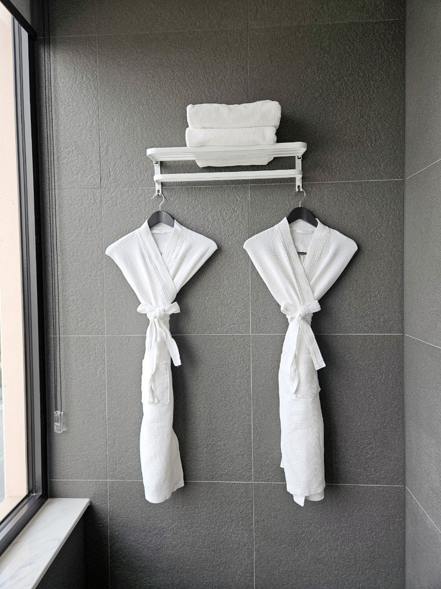 Tanibay Hotel bathrobes and folded bath towels in bathroom