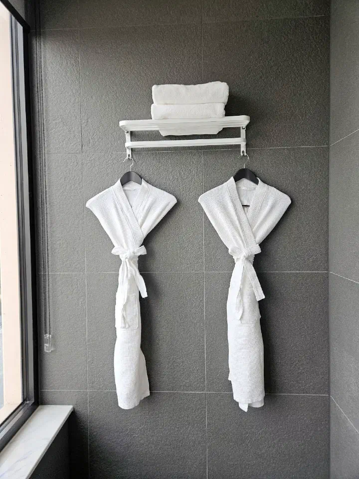 Tanibay Hotel bathrobes and folded bath towels in bathroom