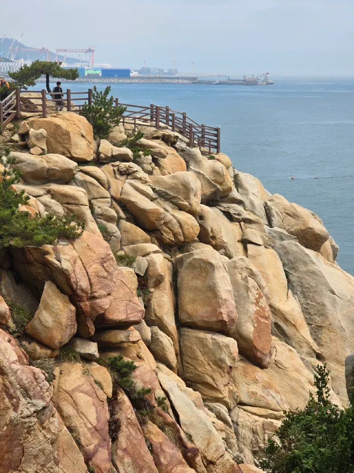 Reddish rock formations along the Daewangam coast