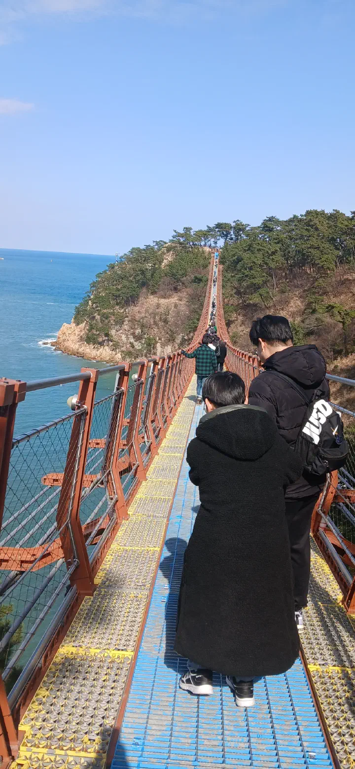 Sea visible through the mesh floor of the Daewangam suspension bridge