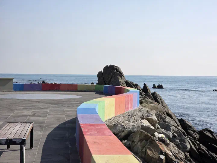 The rainbow-painted barrier wall photo spot at Ganjeolgot